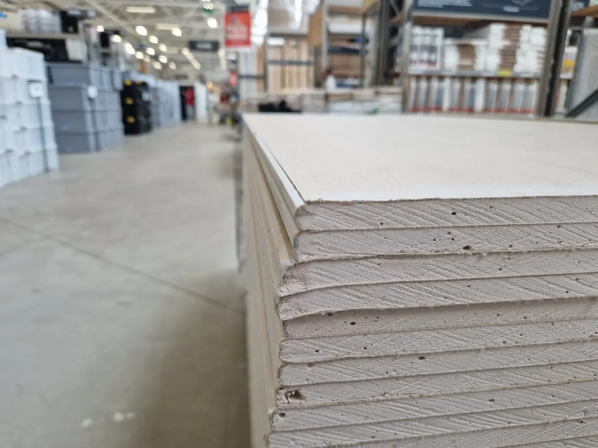 Stacked plasterboard sheets ready for fitting