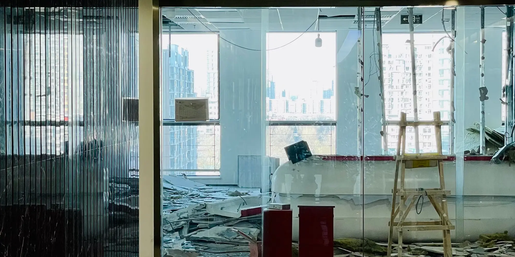 Empty office floor mid-refurbishment with the city through the glazing
