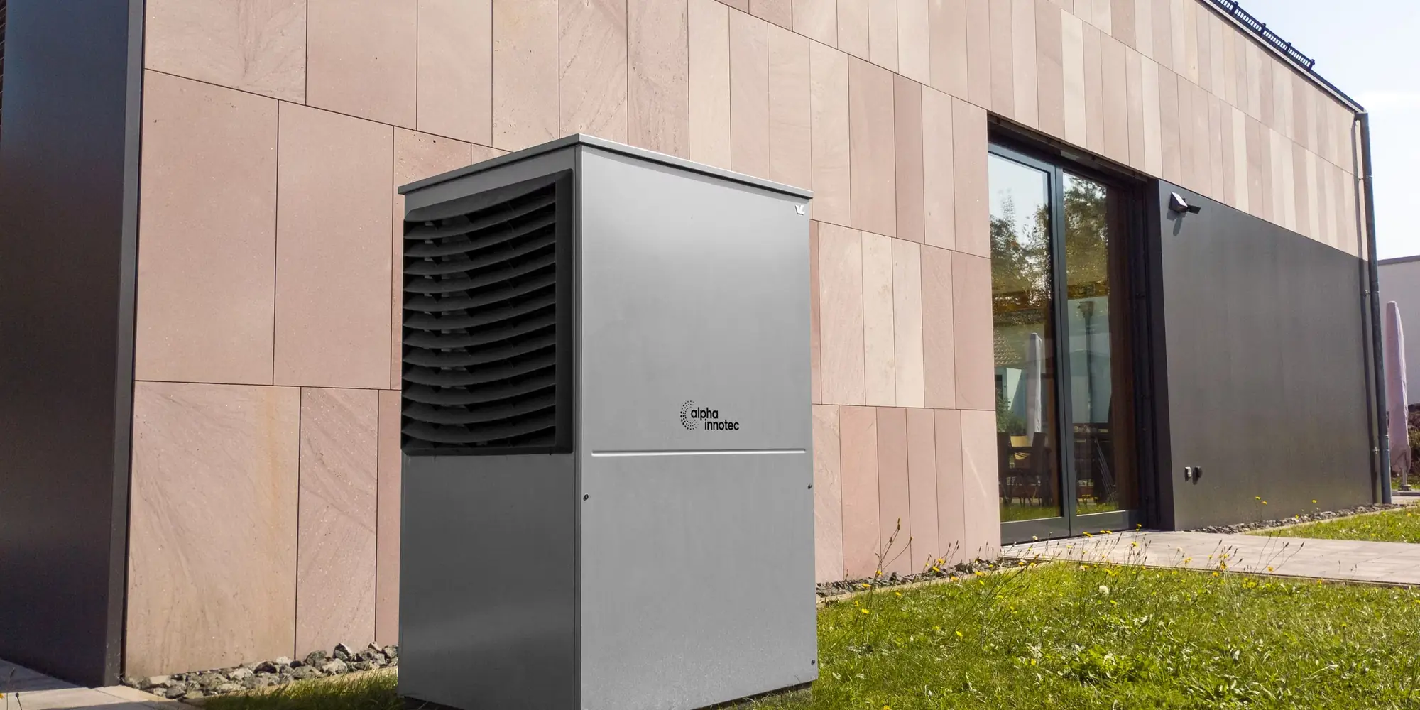 Modern air source heat pump unit outside a house