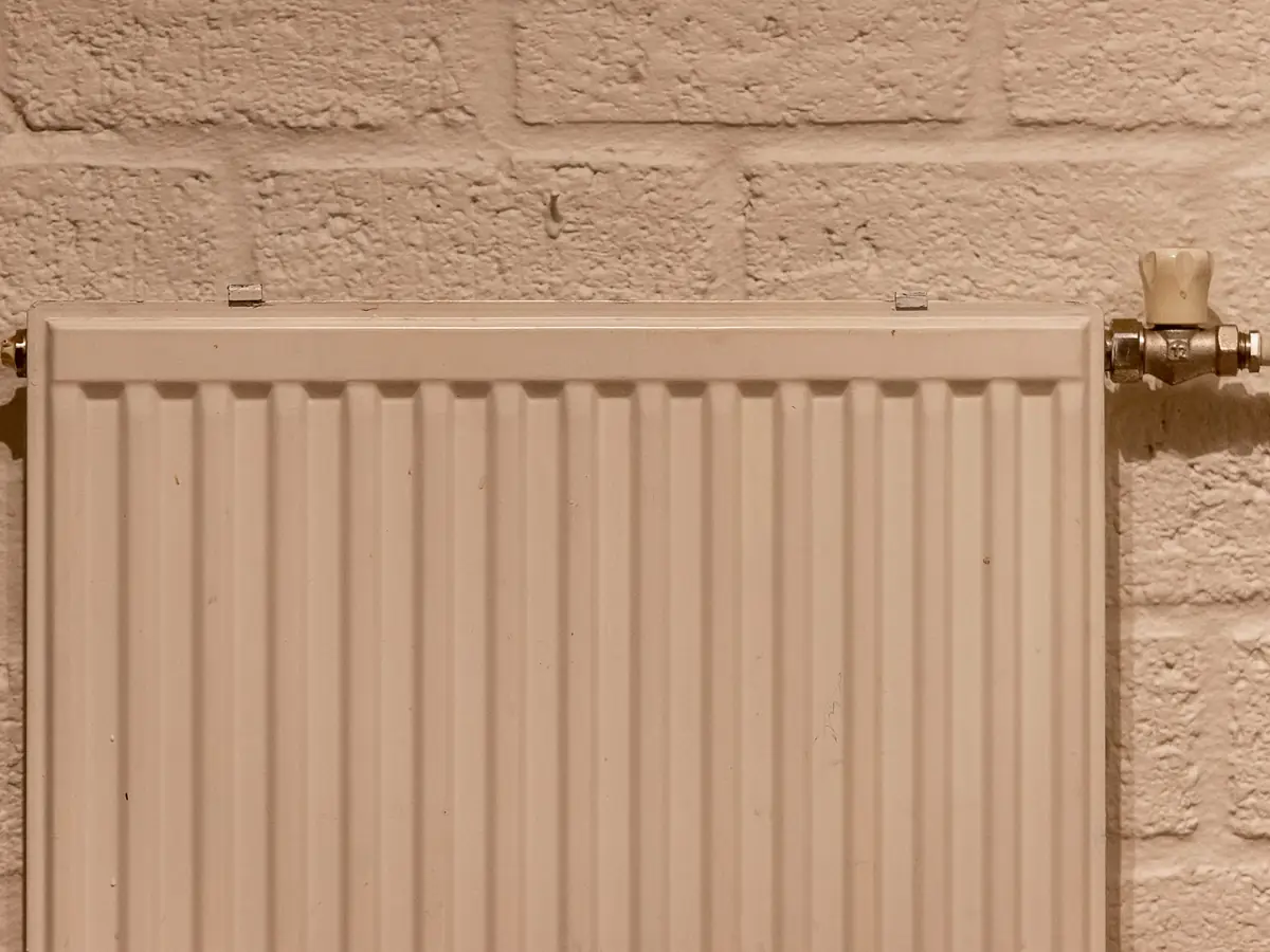 White radiator against a textured internal wall