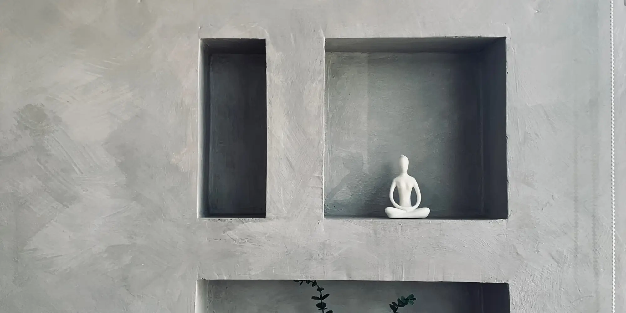 Grey polished plaster wall with recessed display niches